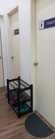 A rack of complimentary slippers outside the Student Lounge washroom doors
