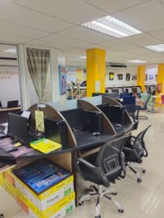 Individual study carrels in the library, with task chairs and shelving beyond