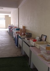 A long self-service food counter at Level 3, lined with covered trays and containers of prepared food