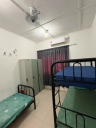 An upgraded hostel room with a bunk bed, new mattresses, dedicated wardrobes, a wall fan, air conditioning, and newly installed curtains