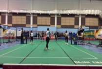 A badminton match under way on an indoor court during the sports tournament