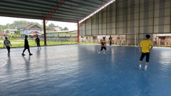 A futsal match on an outdoor covered court