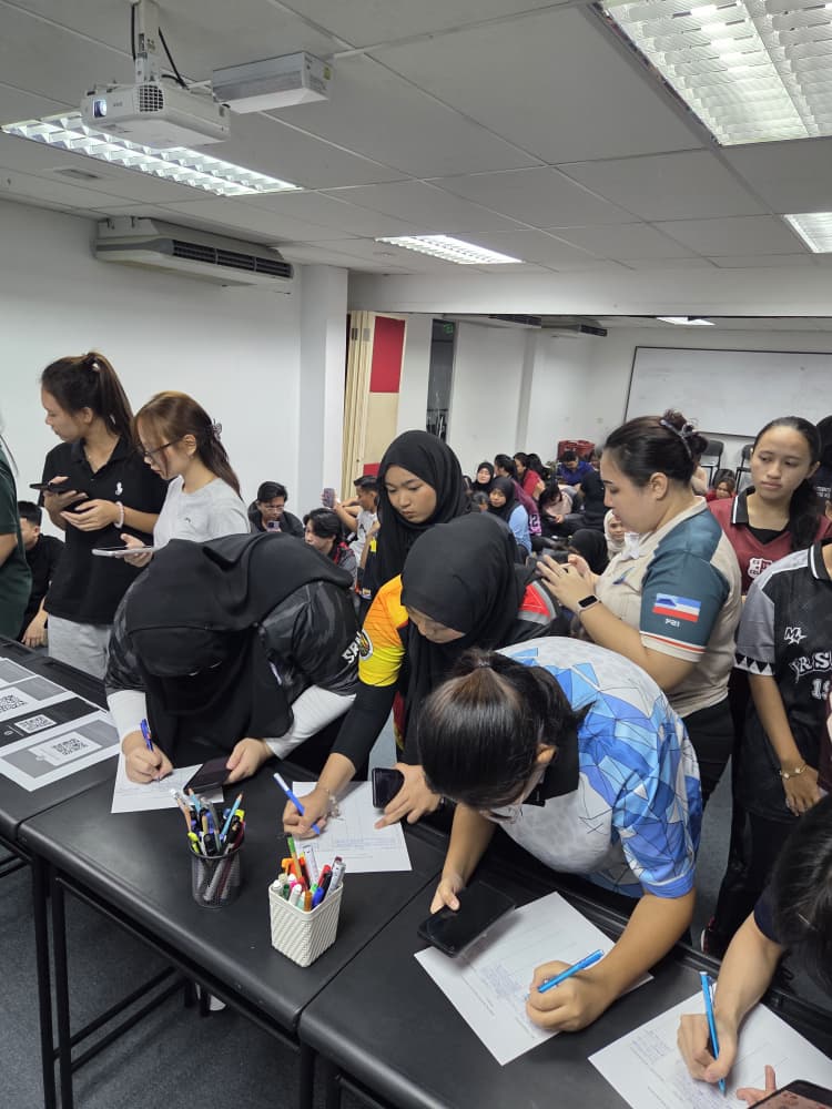 Students signing up at registration tables during a campus event