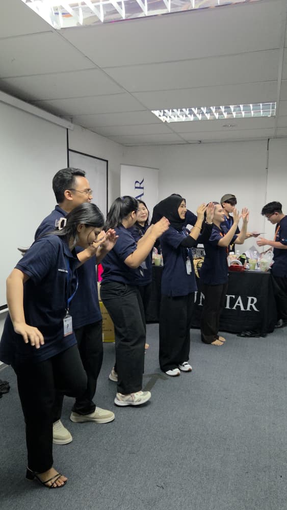 Staff and students high-fiving in a line at a campus event
